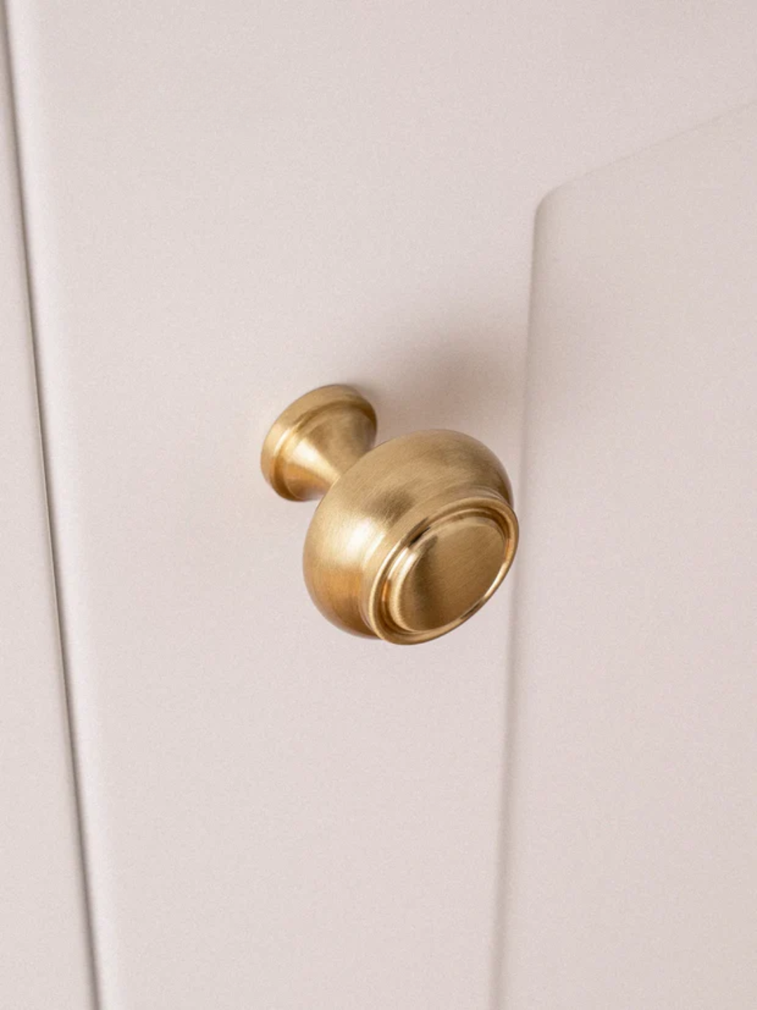 Gold door handle on a white door