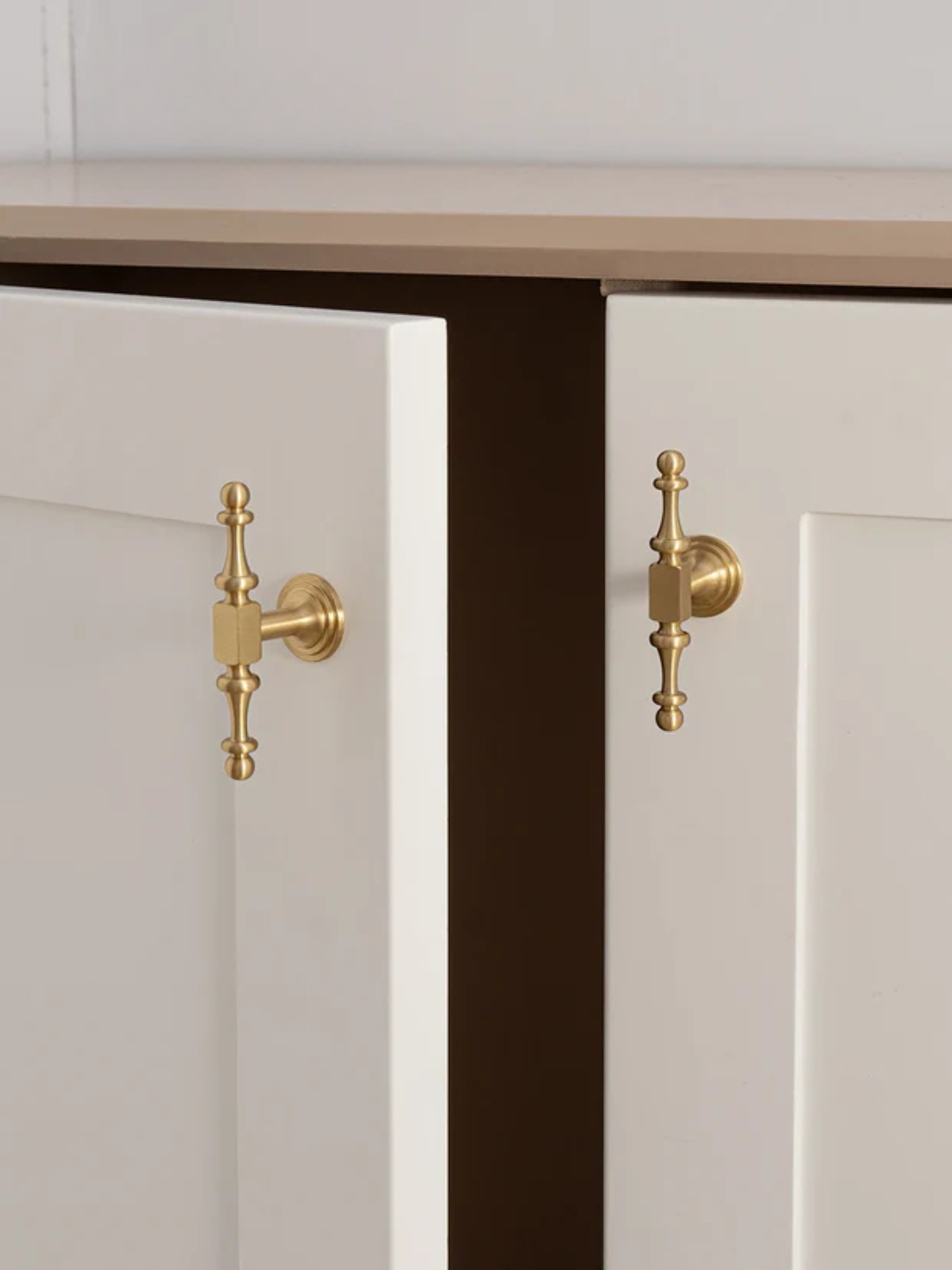 Cabinet doors with gold handles and 'Santaya' branding.