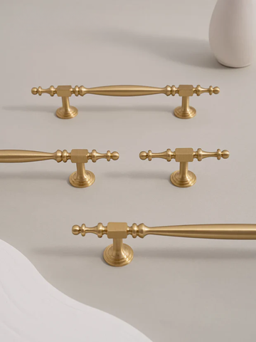 Set of gold handles on a neutral background