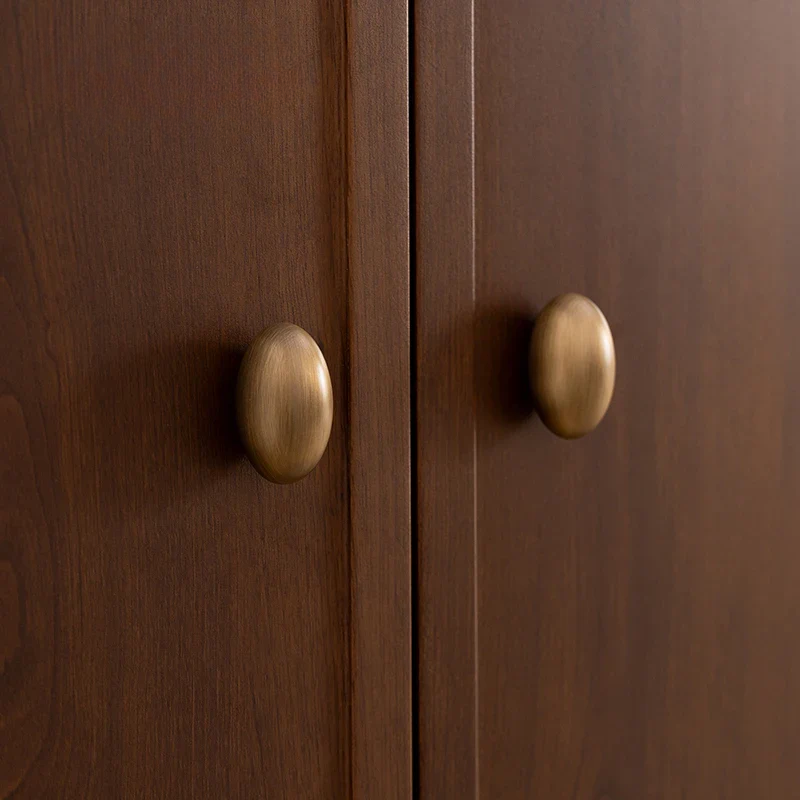 Close-up of wooden cabinet doors with brass handles