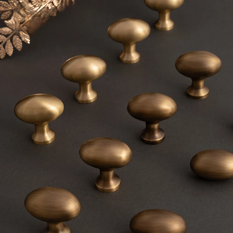 Bronze cabinet knobs on a dark surface