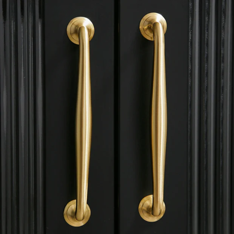 Gold cabinet handles on a black cabinet