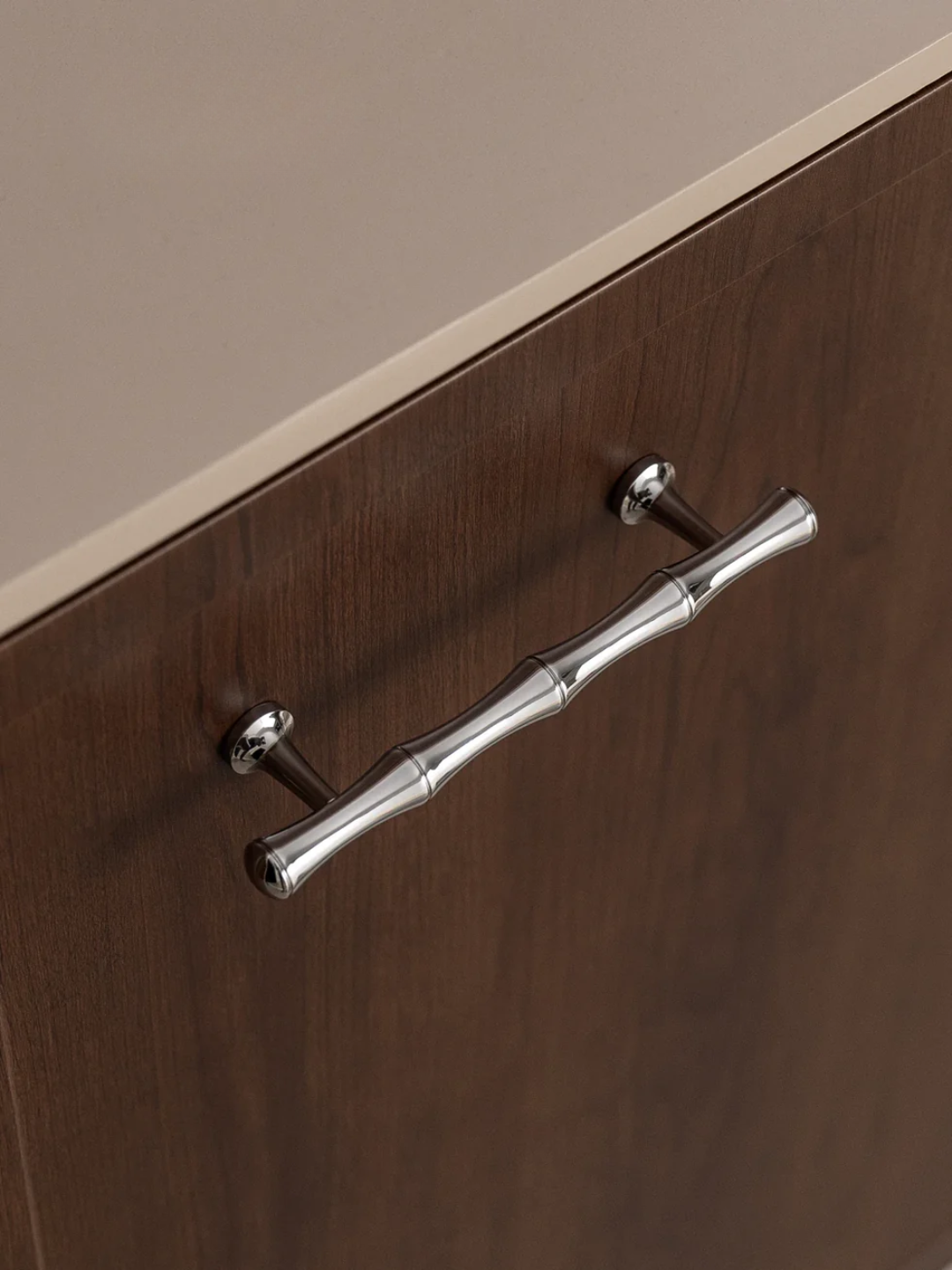 Close-up of a wooden drawer with a silver handle