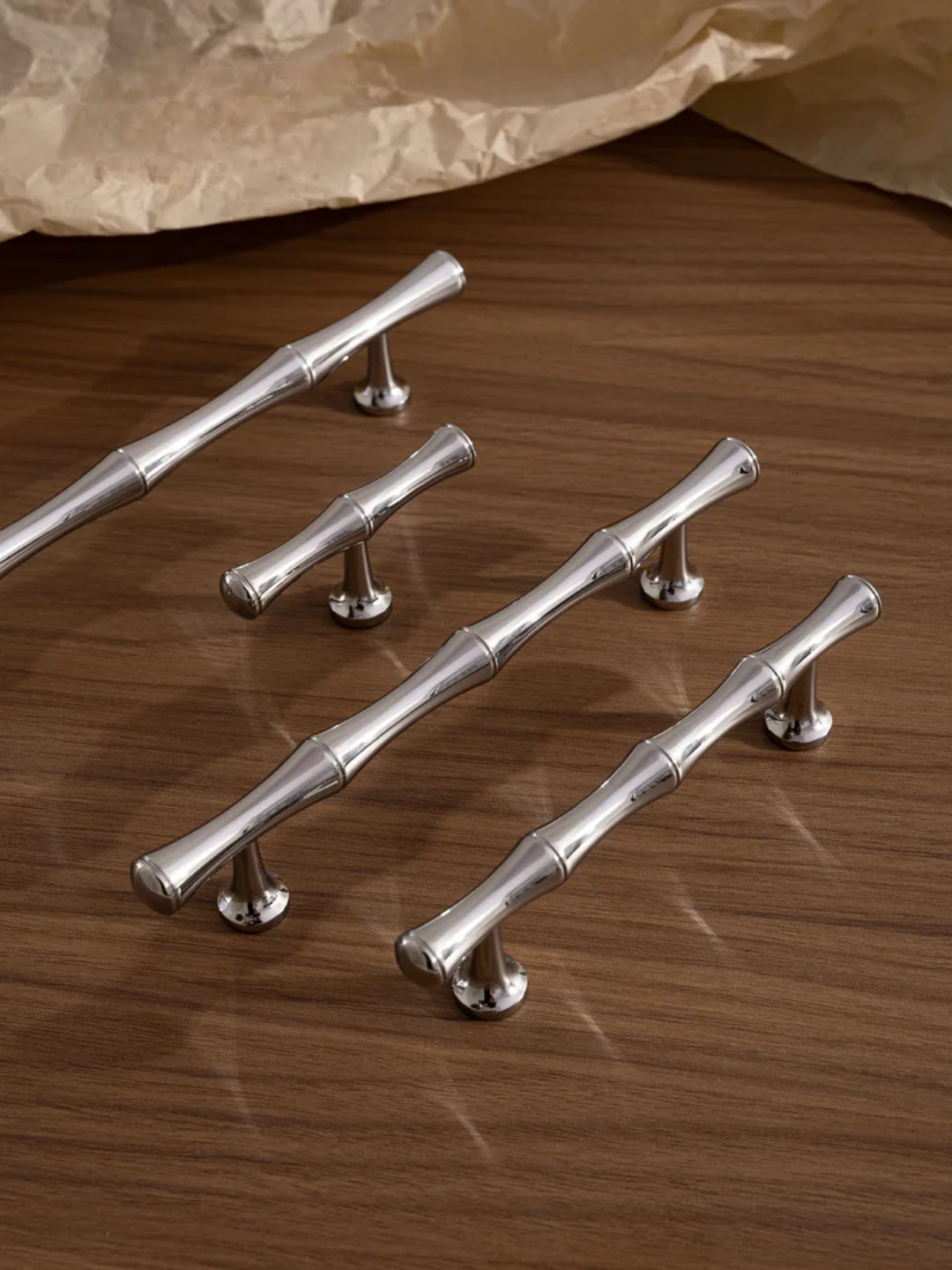 Set of silver cabinet handles on a wooden surface