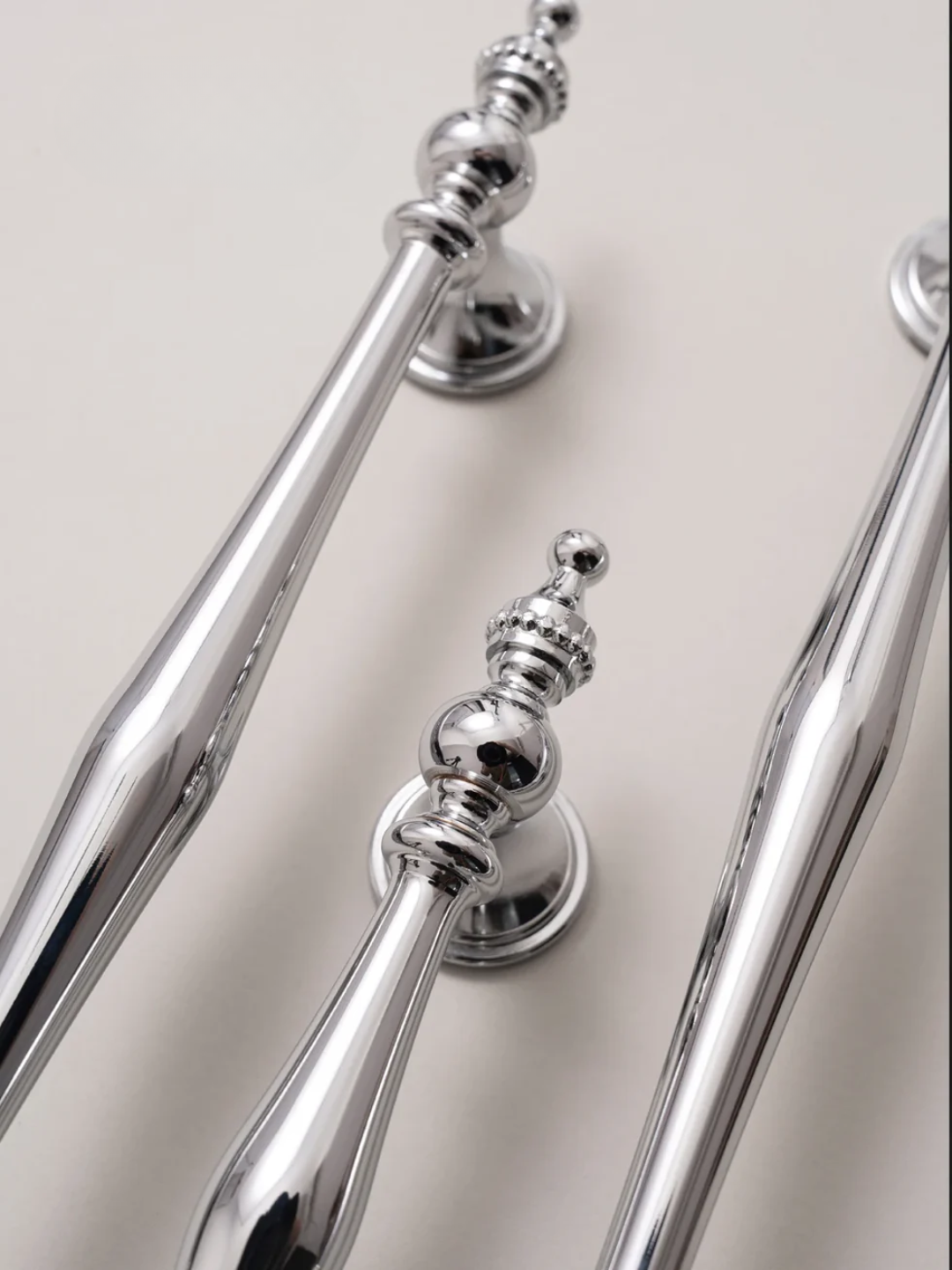 Close-up of silver handles on a door or cabinet.