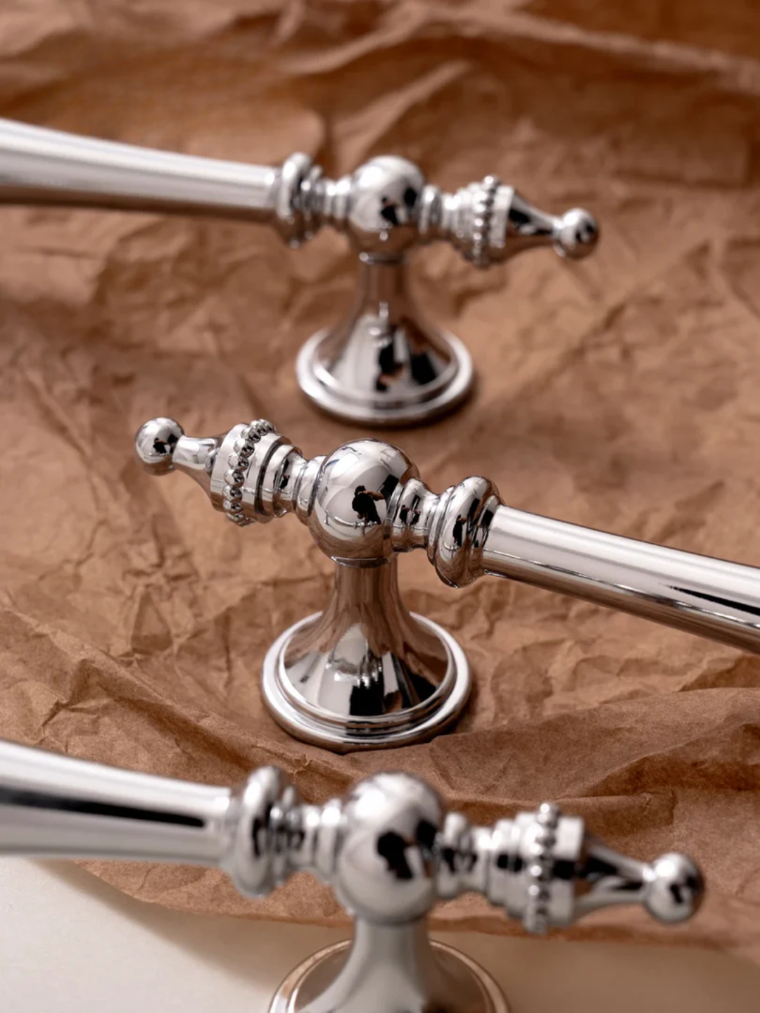 Set of silver handles on a textured surface with 'Santaya' branding.