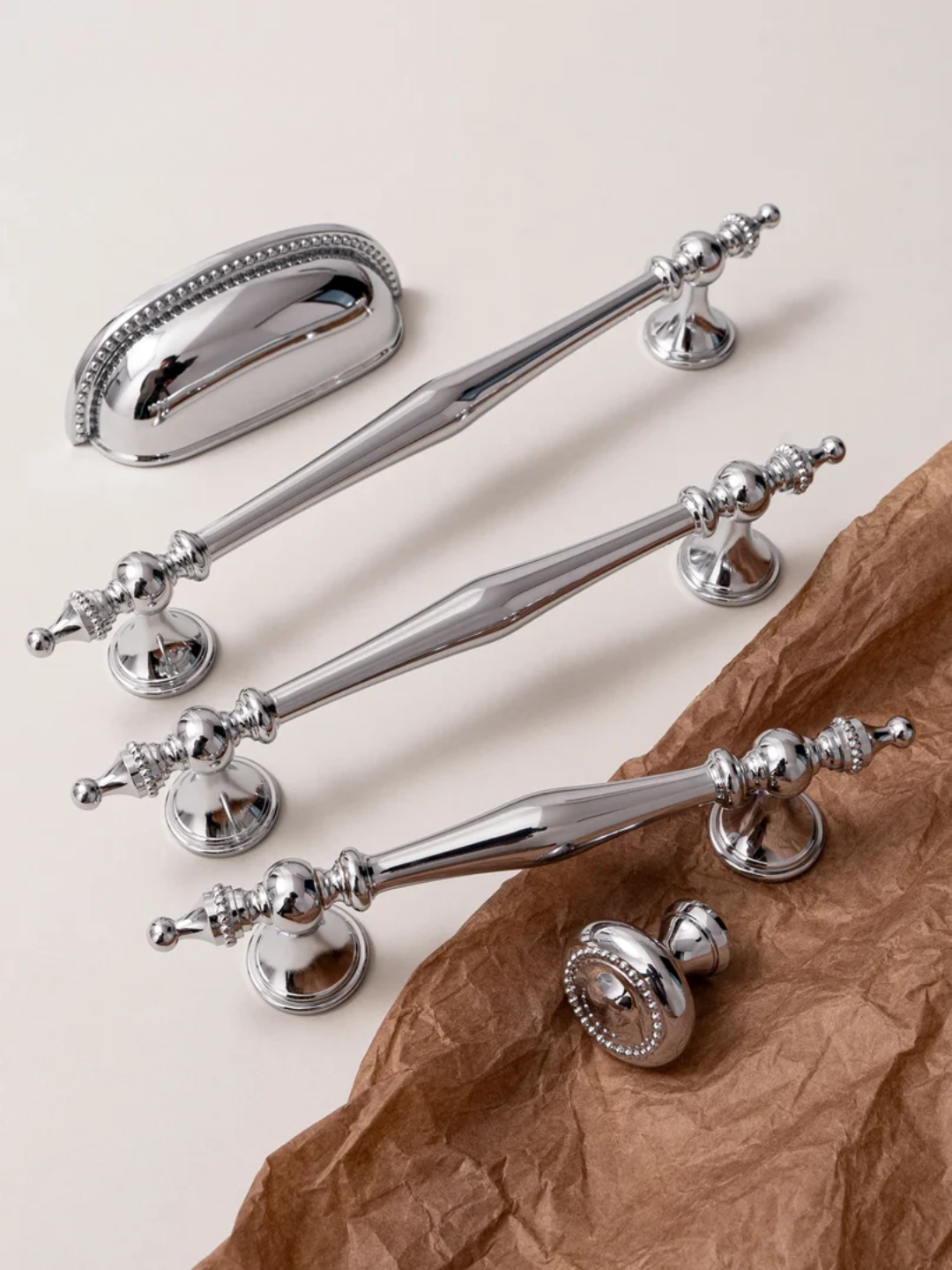 Set of silver handles on a textured surface with 'Santaya' branding.