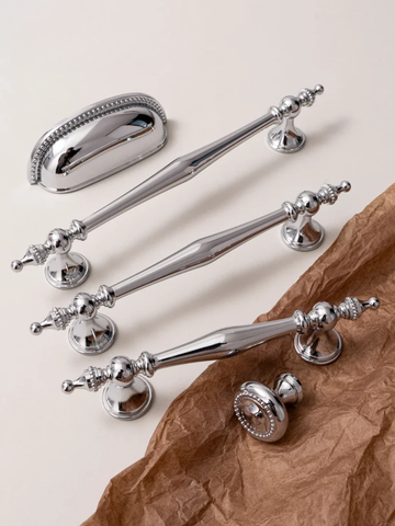 Set of silver handles on a textured surface with 'Santaya' branding.