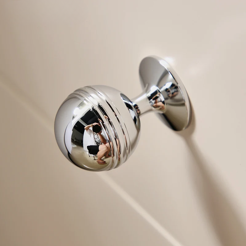 Chrome door handle on a beige door