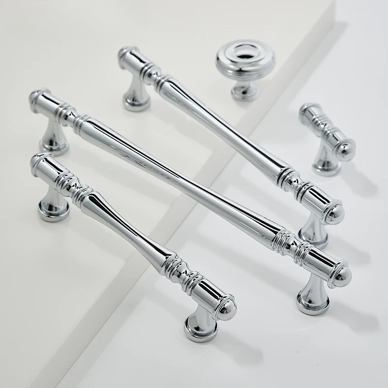 Set of silver cabinet handles on a white background