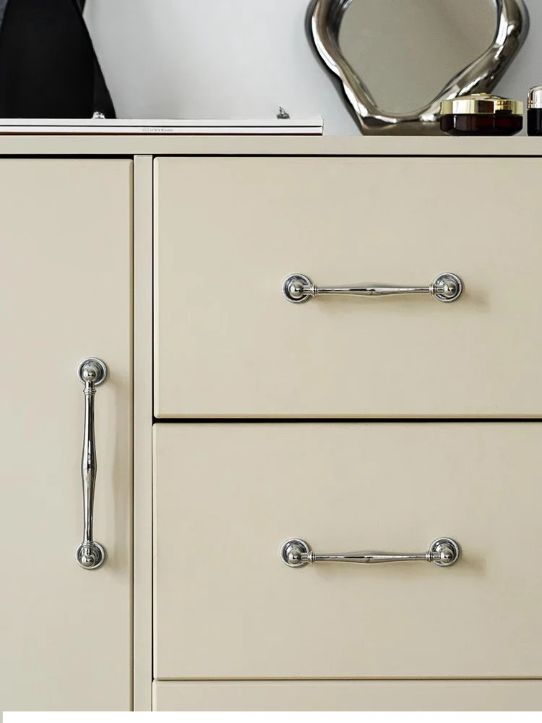 Beige cabinet with silver handles on a white background
