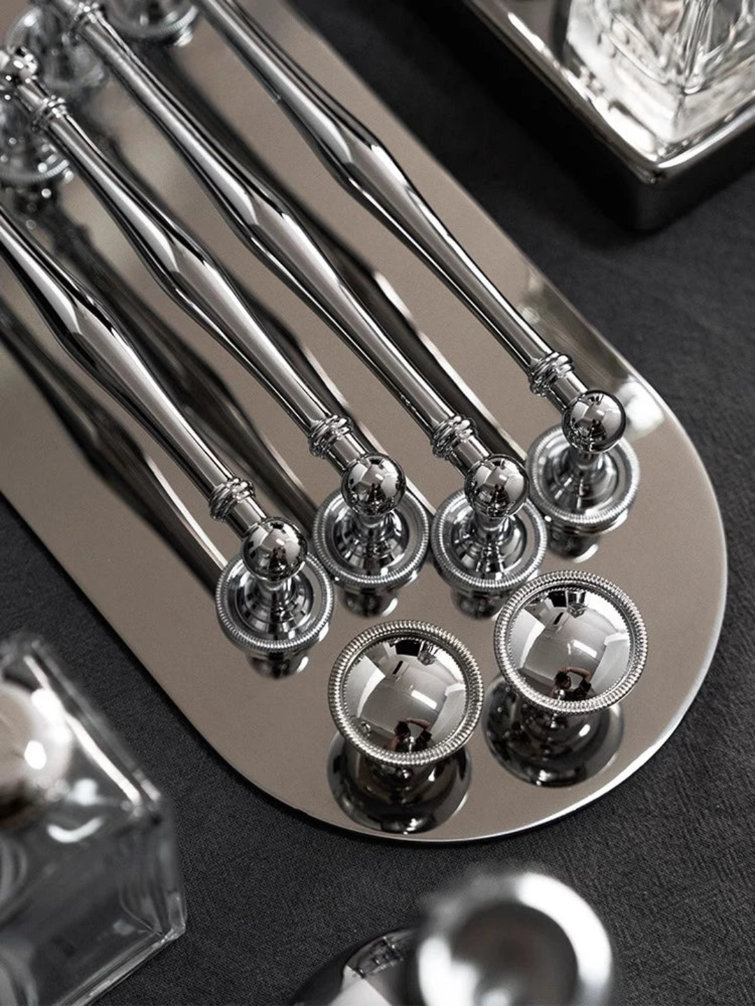 Set of silver spoons on a dark surface