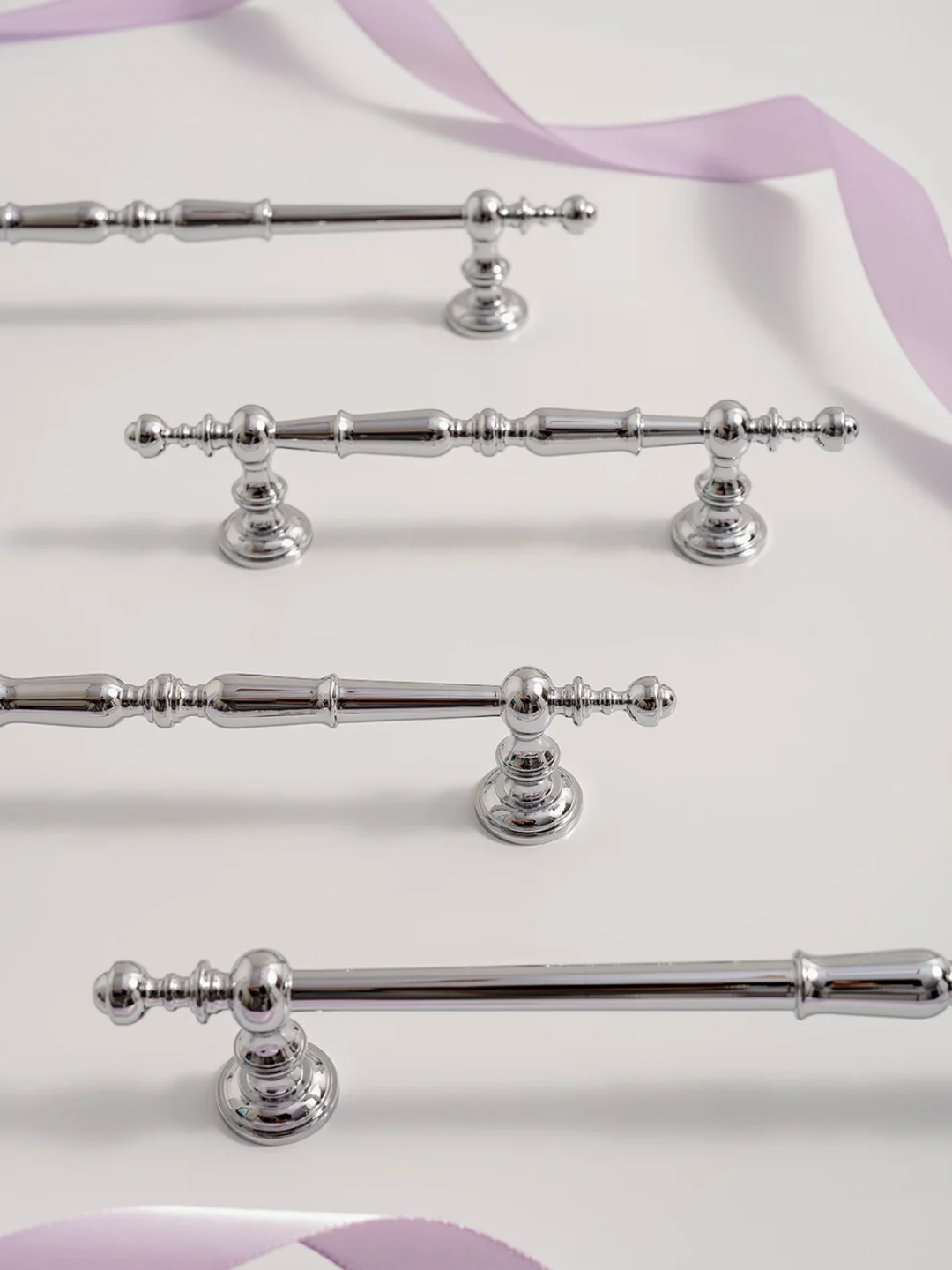 Set of silver decorative rods on a white background with purple accents