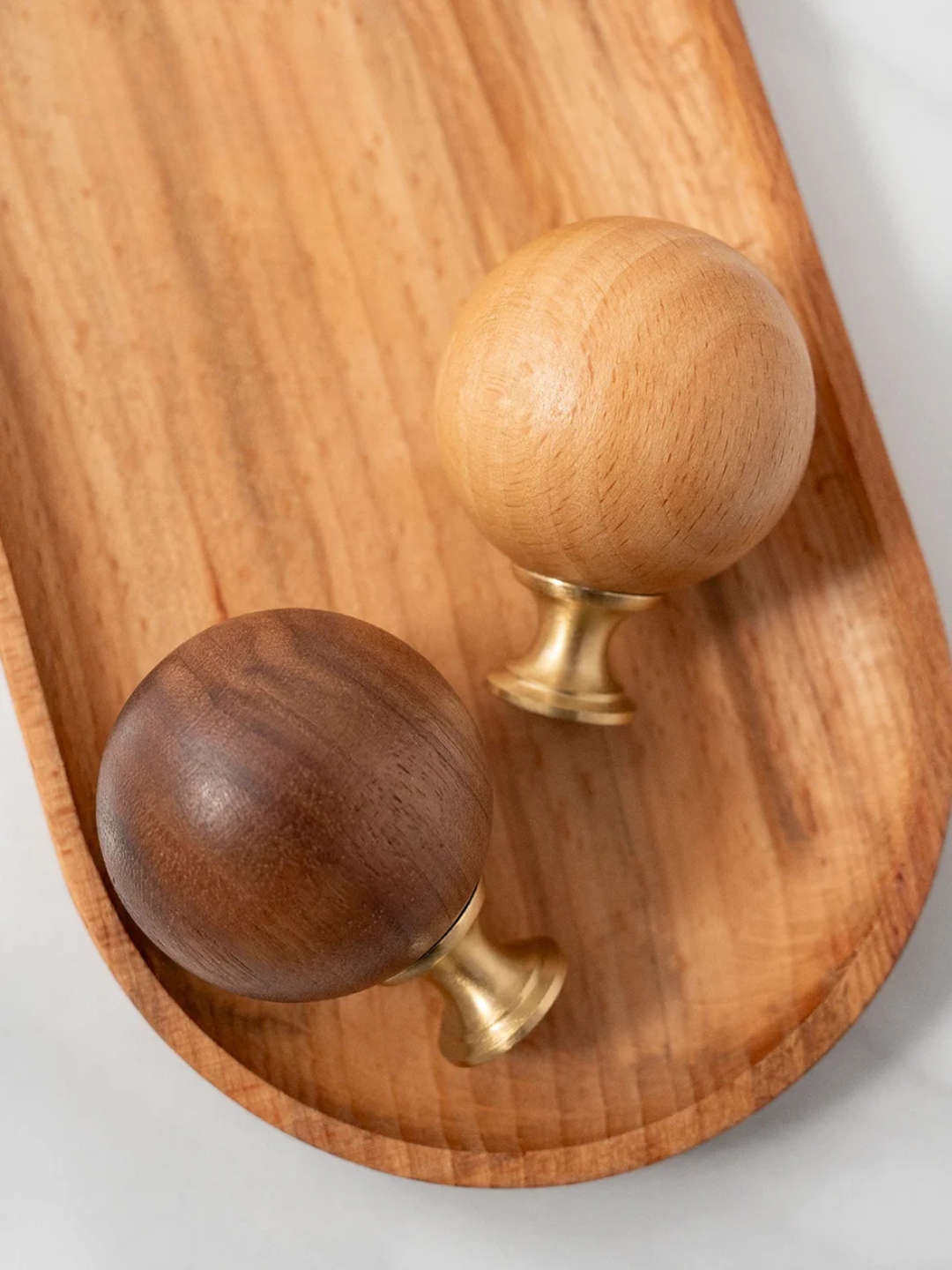 Wooden handles with brass fixtures on a wooden surface