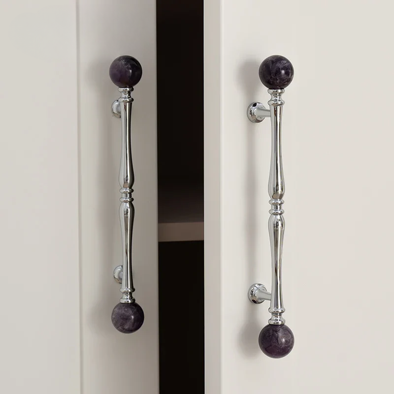 Cabinet doors with pink spherical knobs on a white background
