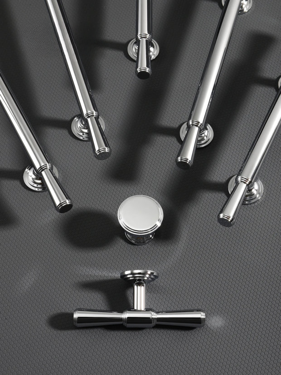 Collection of metallic door handles on a textured gray surface