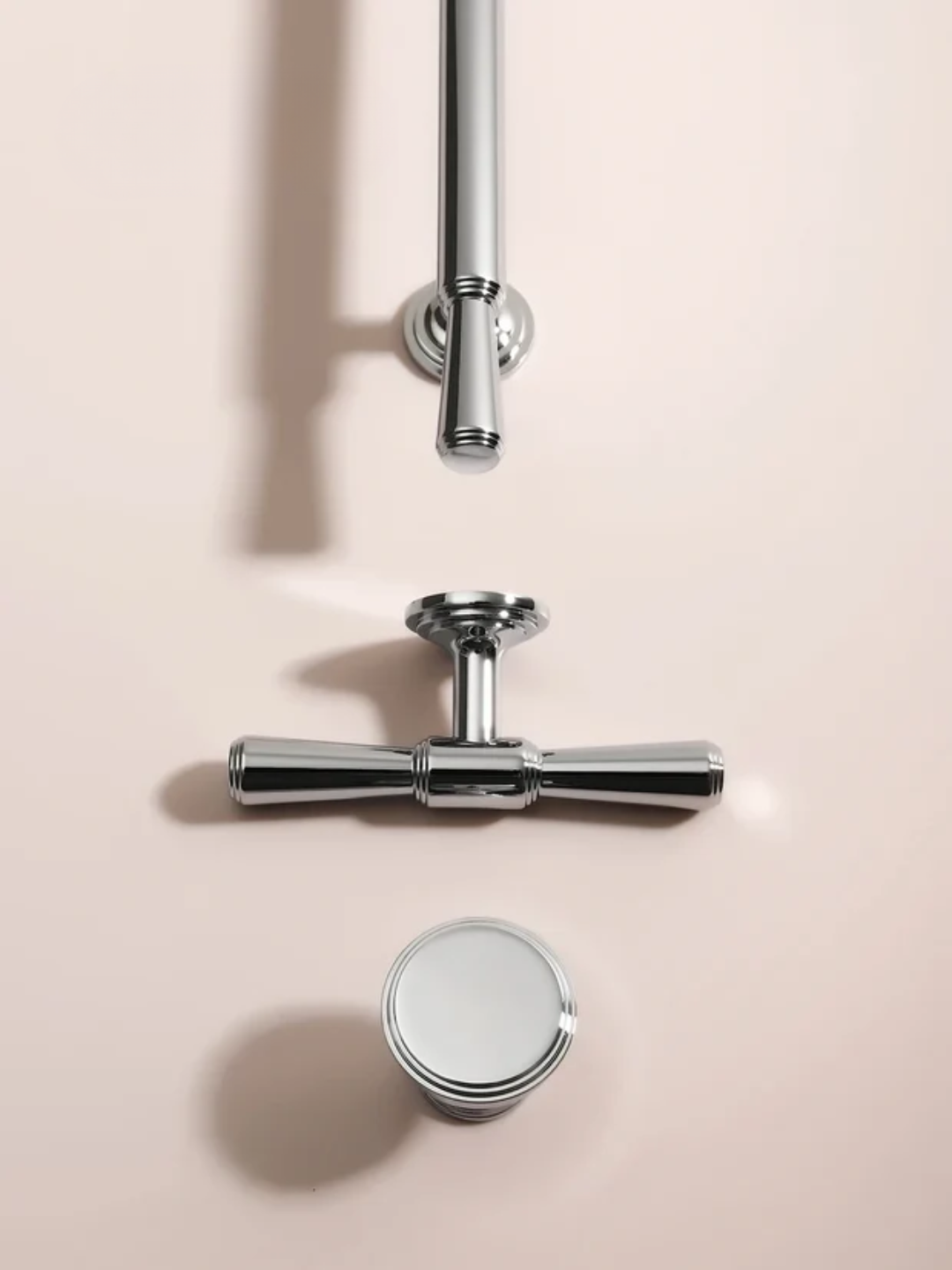 Chrome bathroom fixtures on a beige background