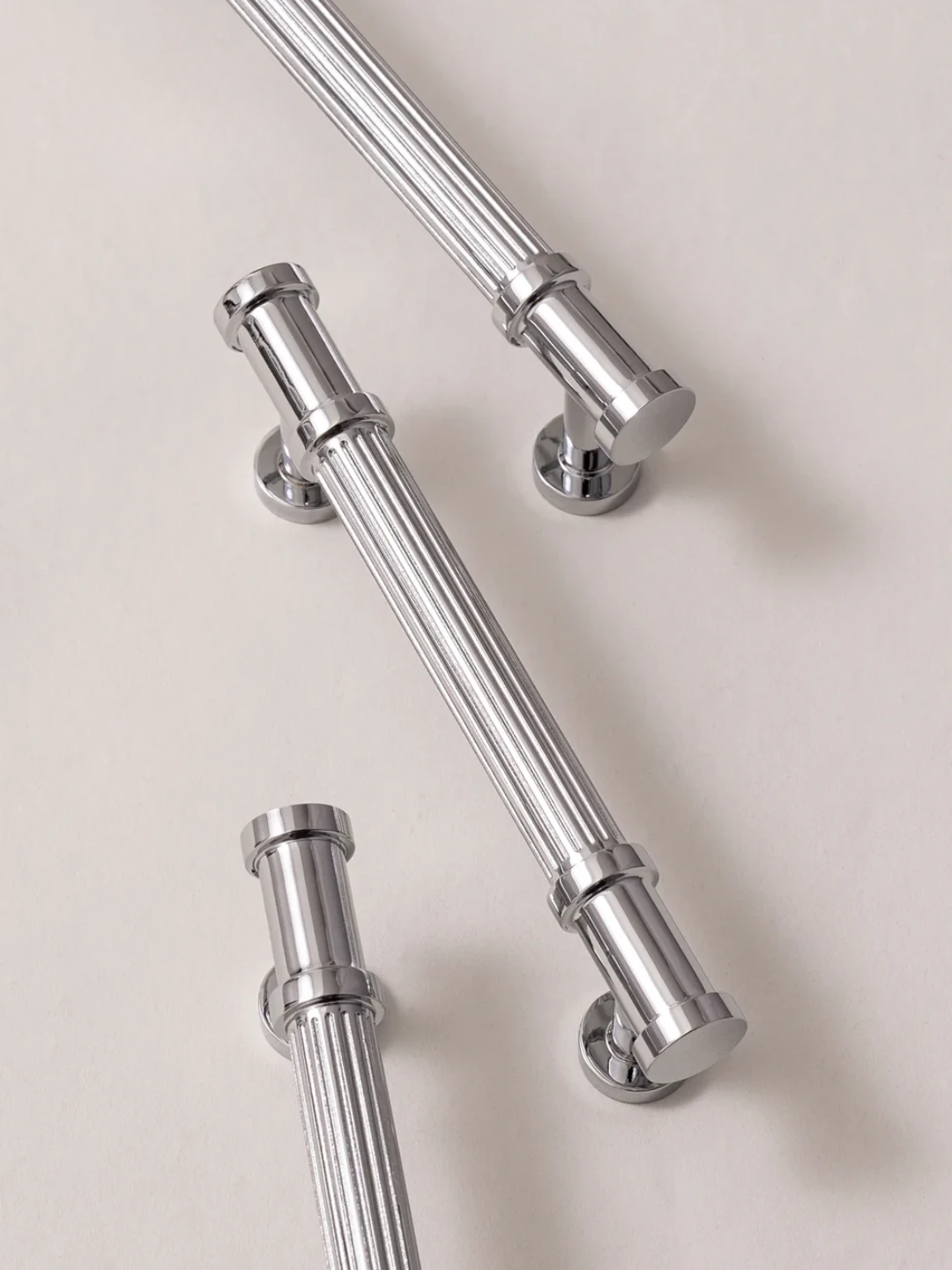 Chrome towel bars on a beige background