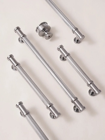 Set of chrome cabinet handles on a light background
