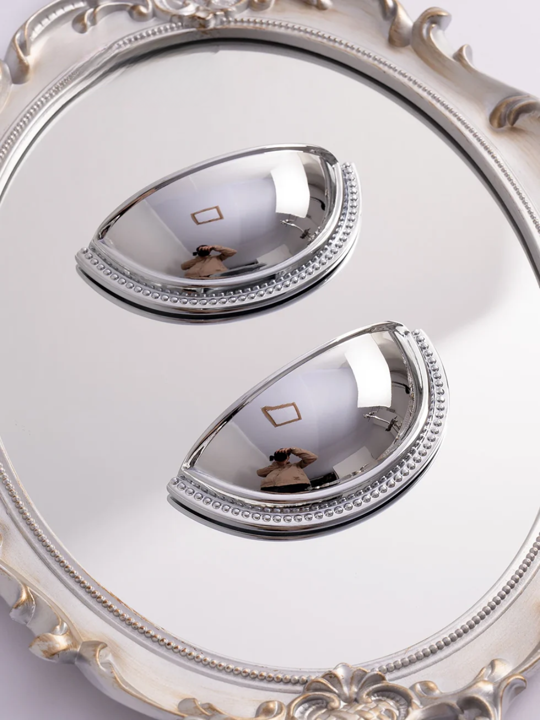 Close-up of a decorative mirror with intricate details