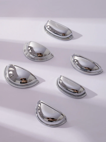 Set of silver teardrop-shaped objects on a light gray background