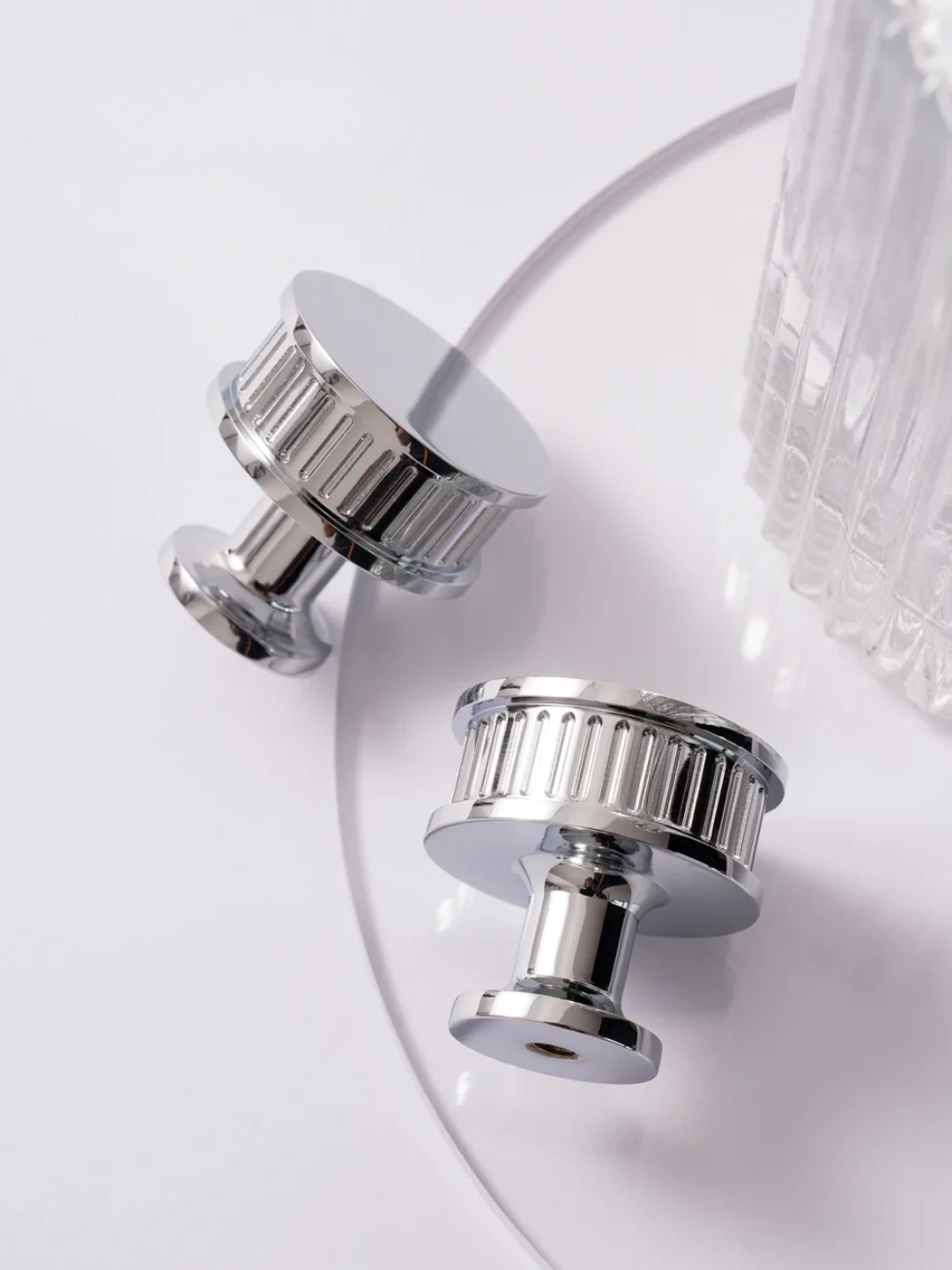 Close-up of a silver light fixture with a white background
