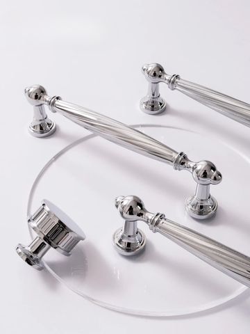 Set of silver bathroom fixtures on a white background