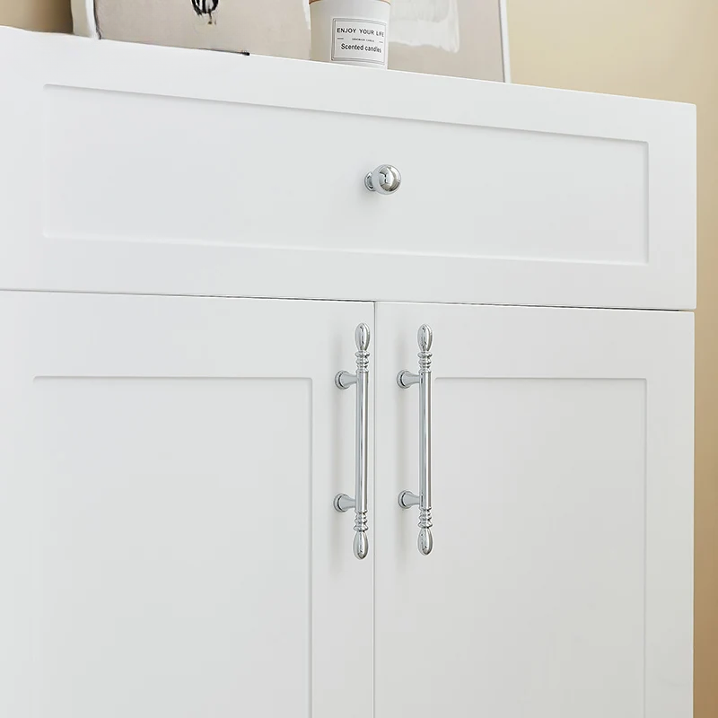 White cabinet with silver handles on a beige wall background
