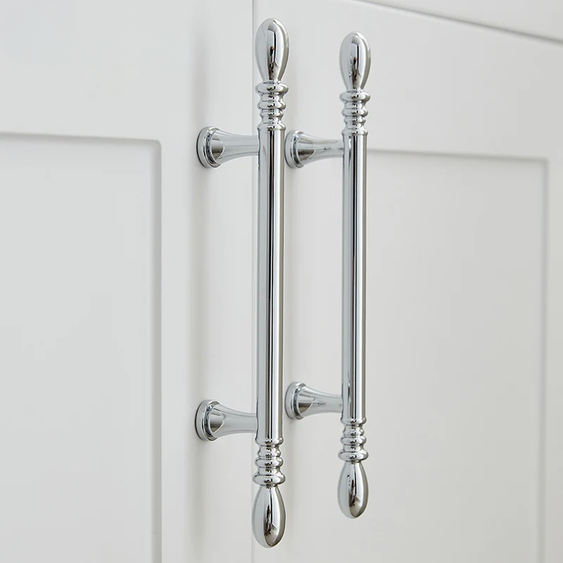 Chrome cabinet handles on a white door