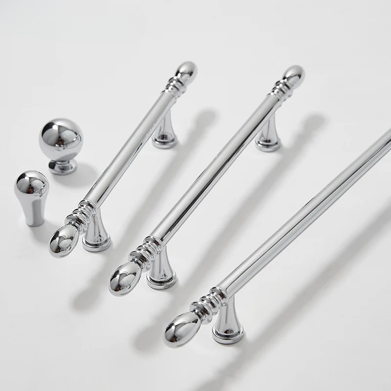 Set of silver door handles on a light gray background