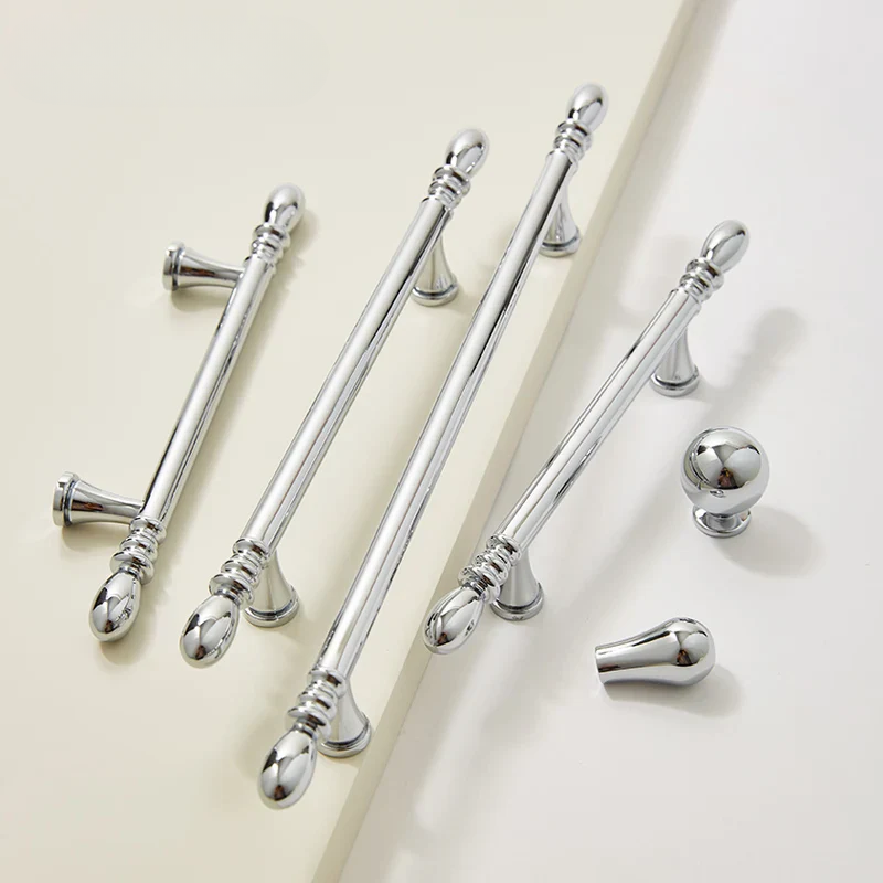 Set of silver curtain rods with decorative finials on a light background