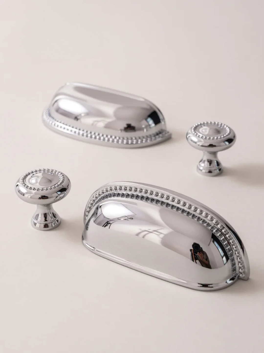 Set of silver cabinet handles on a light blue background
