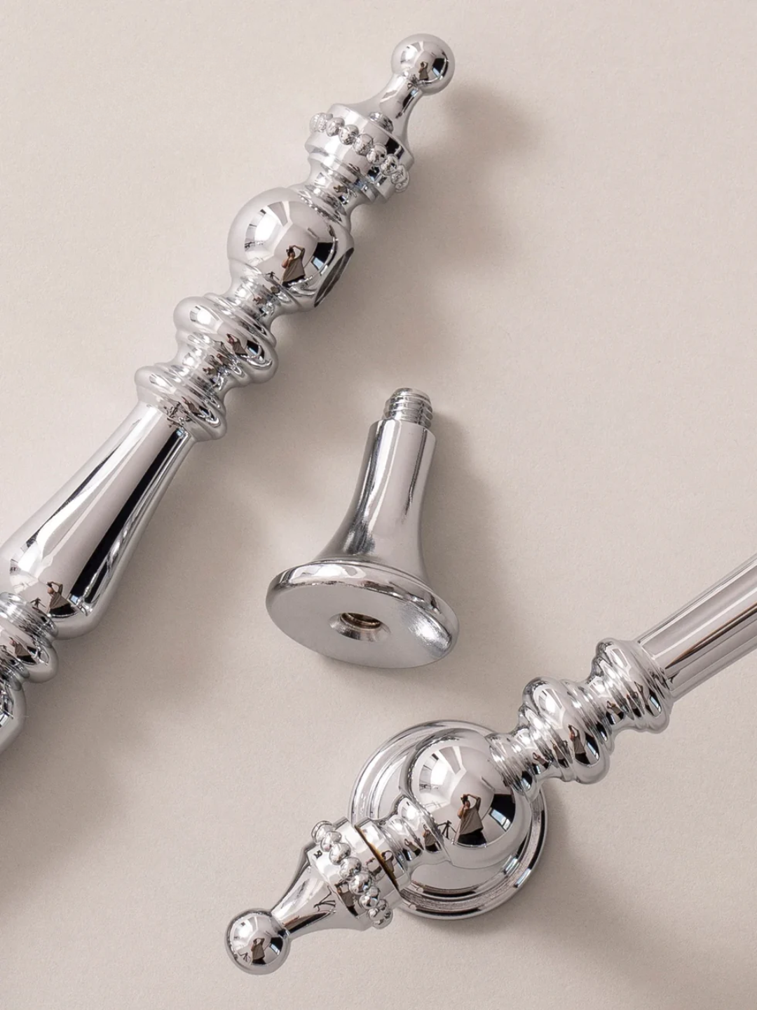Chrome door handles on a beige background