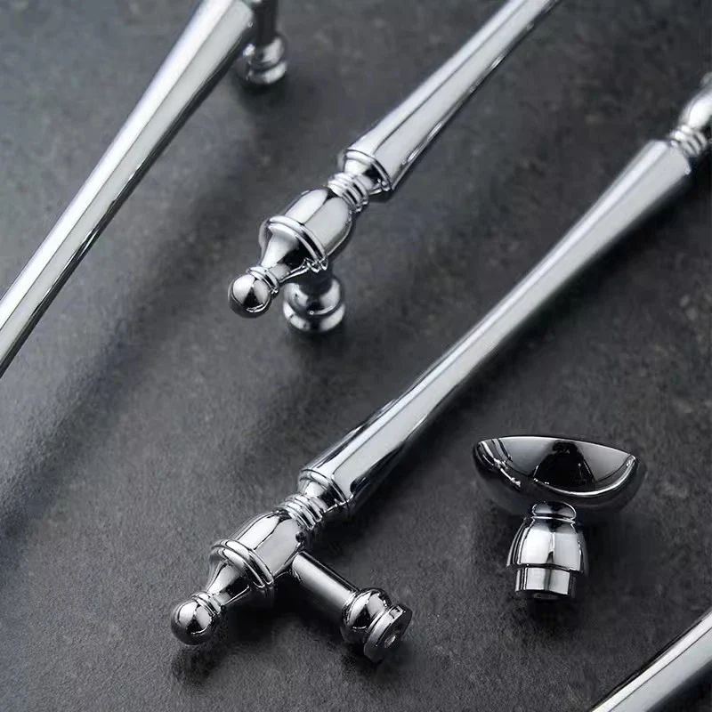 Silver metal handles on a dark surface