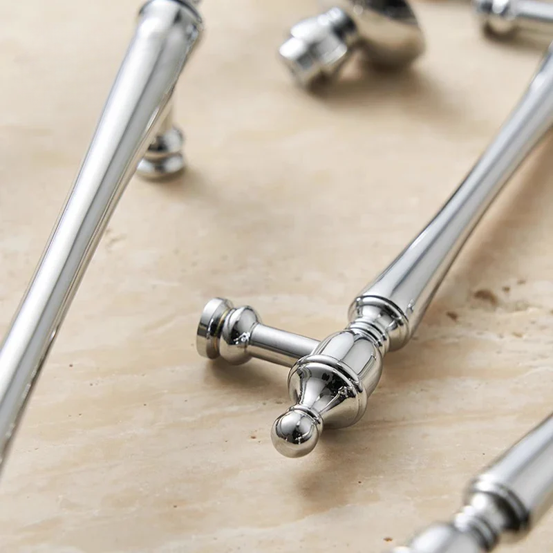 Silver metal handles on a wooden surface
