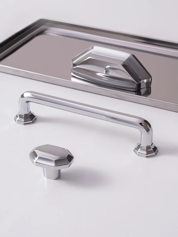 Chrome cabinet handle and knob on a white background