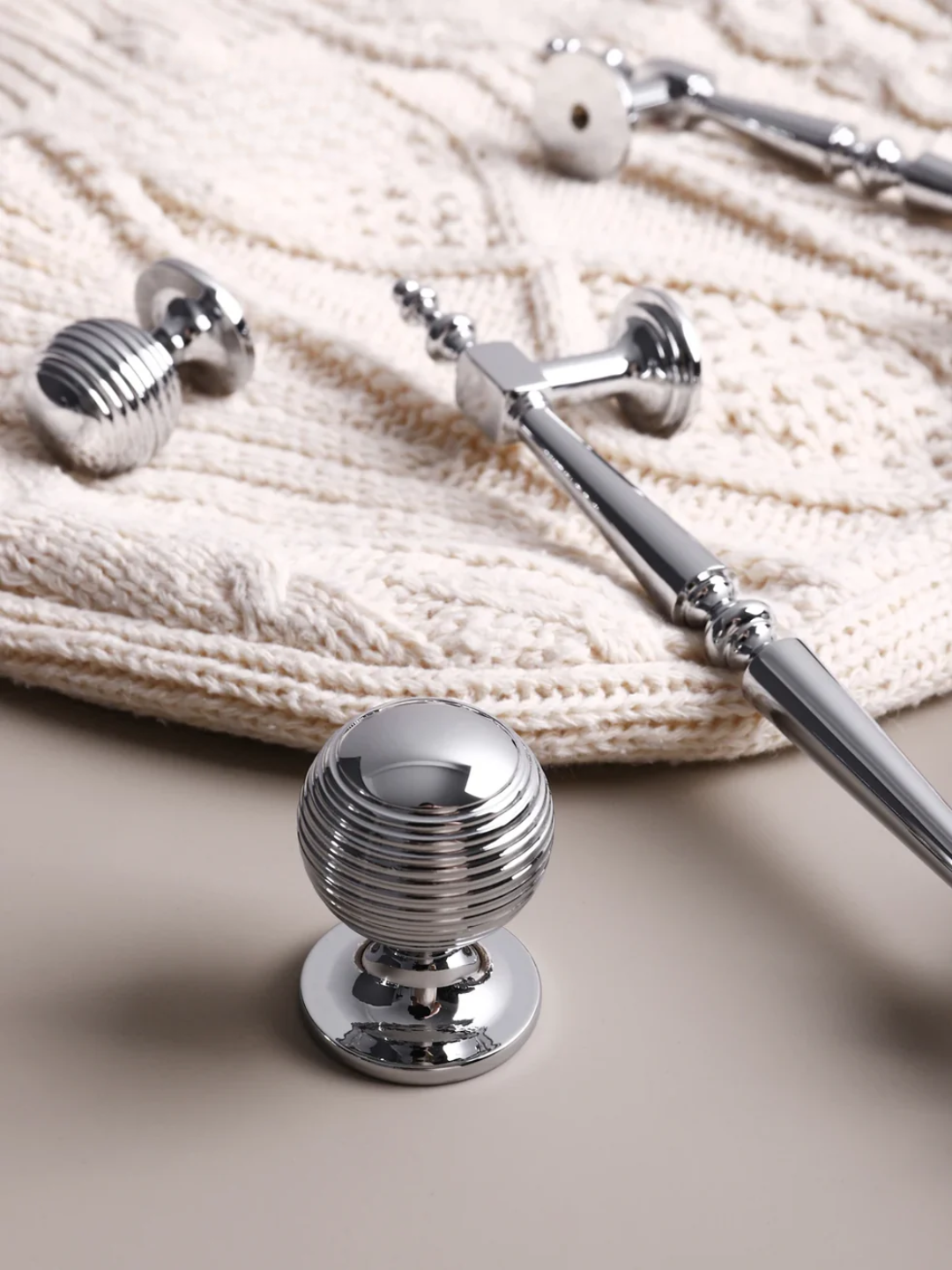 Chrome door handle set on a textured surface