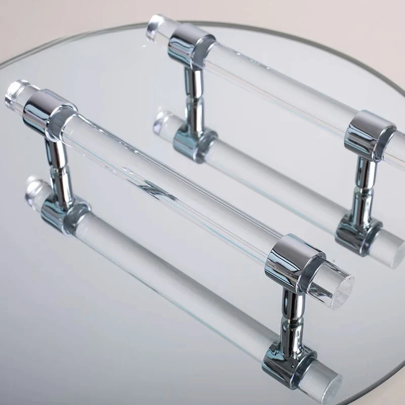 Chrome towel bar with clear acrylic ends on a round mirror