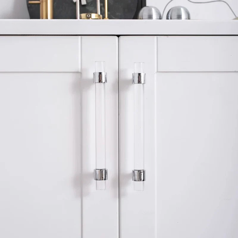 White cabinet with clear glass pulls on a white background