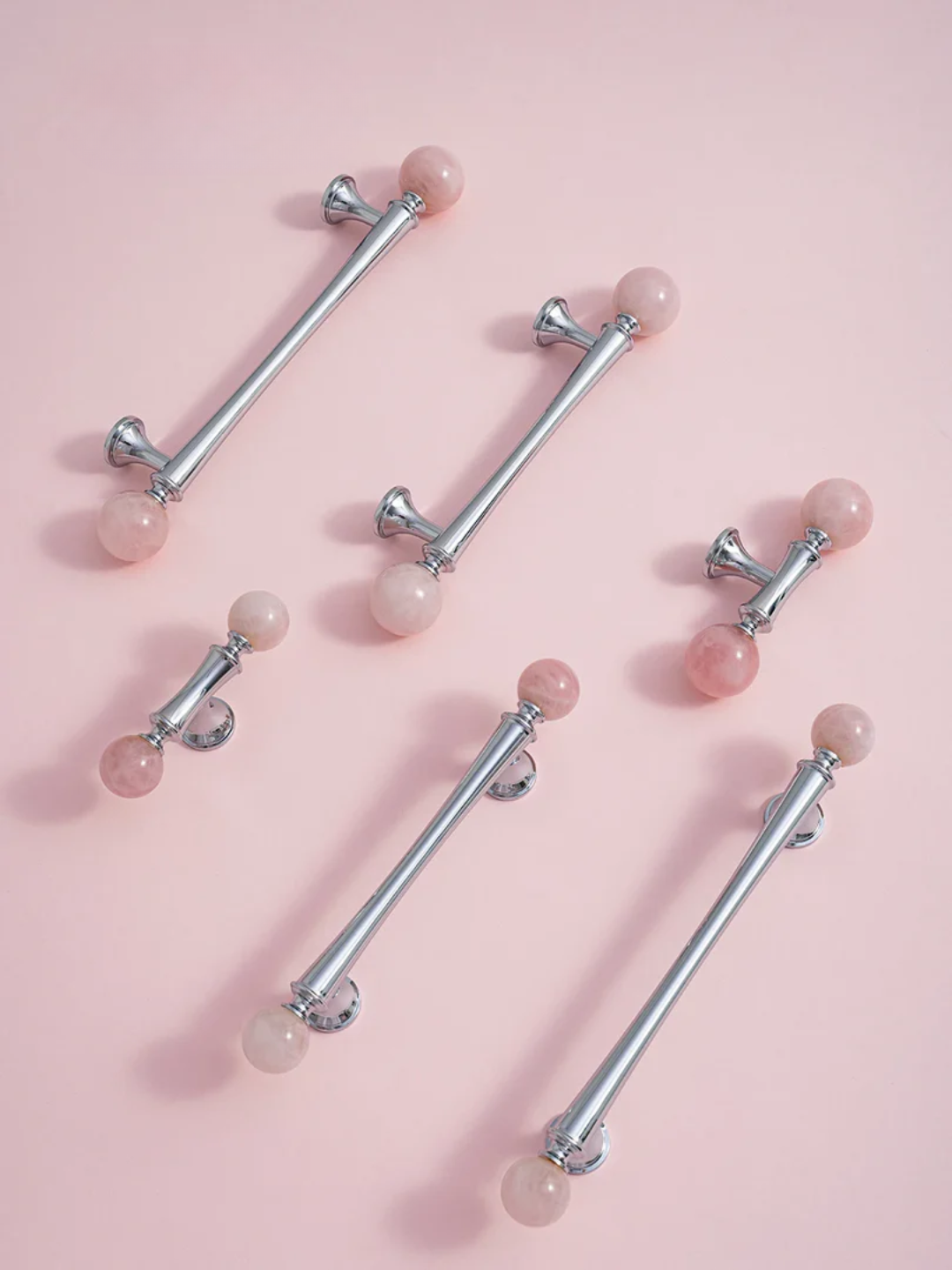 Silver barrettes with pink beads on a pink background
