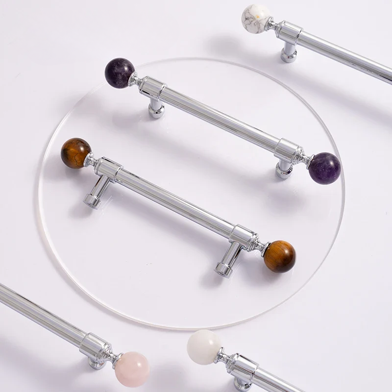 Decorative curtain rods with gemstone ends on a white background