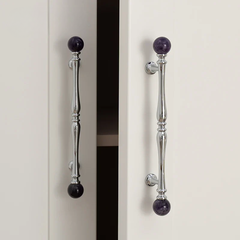 Cabinet doors with decorative handles featuring purple knobs on a neutral background