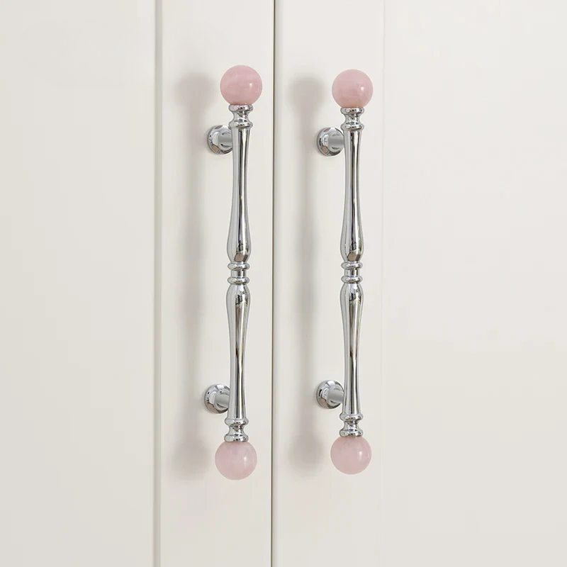 Cabinet doors with pink bead handles on a white background