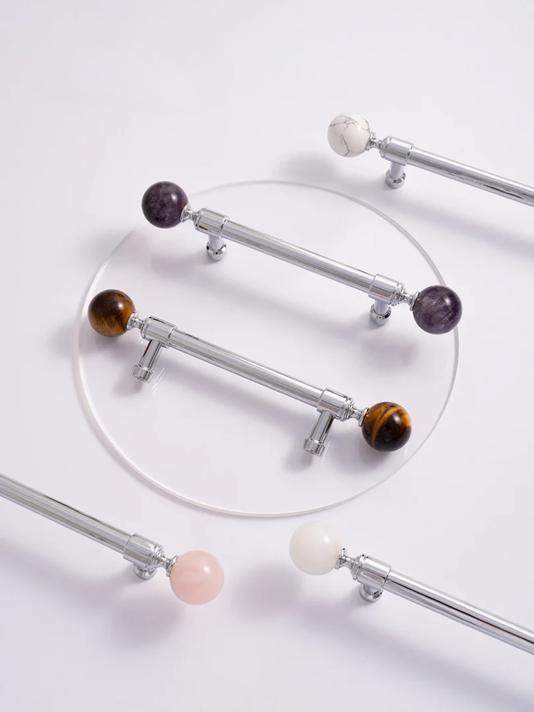 Decorative curtain rods with multicolored spherical ends on a white background