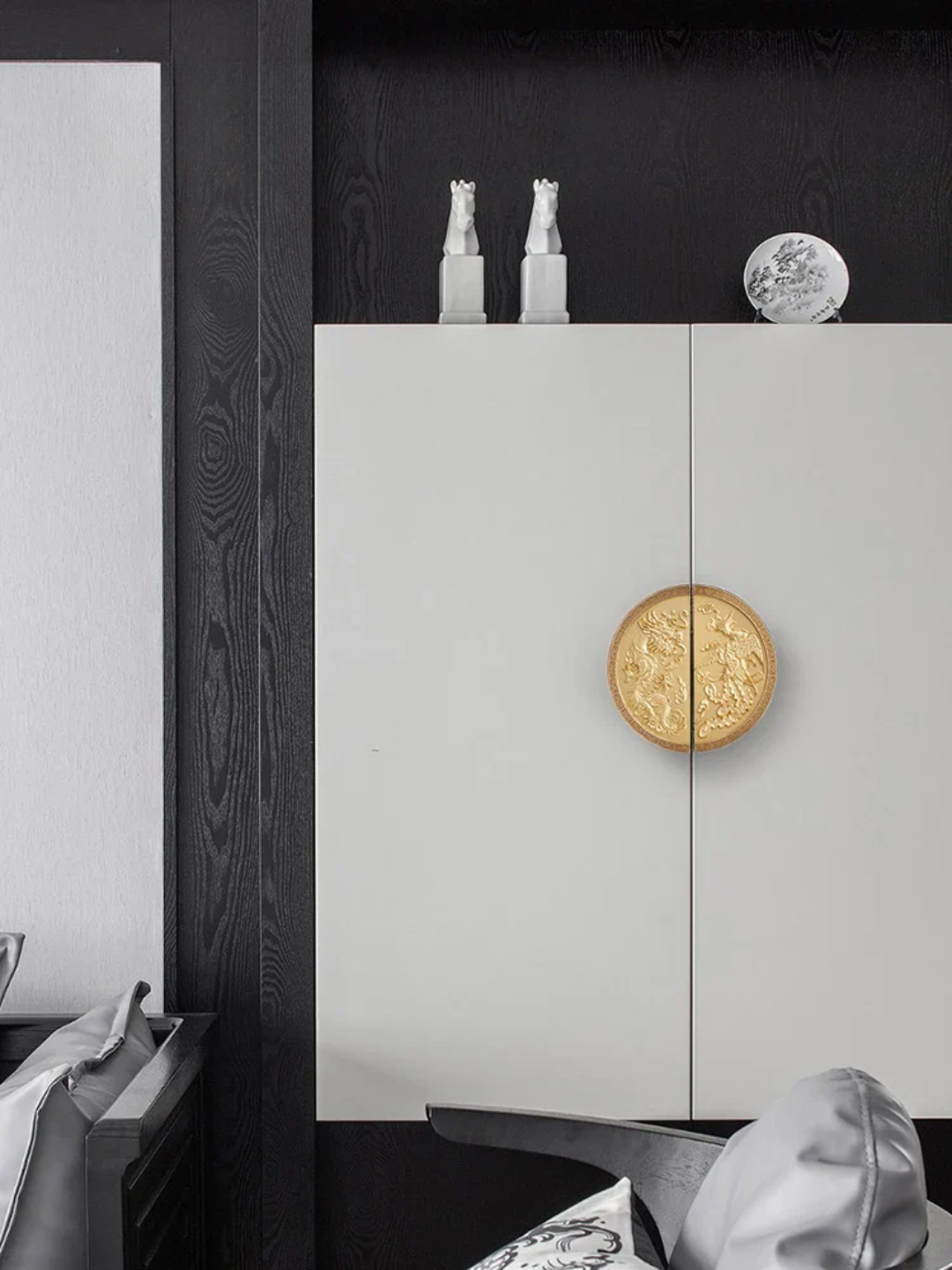 White cabinet with gold circular design in a minimalistic setting