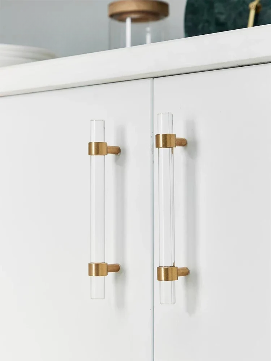 White cabinet with gold and clear handles