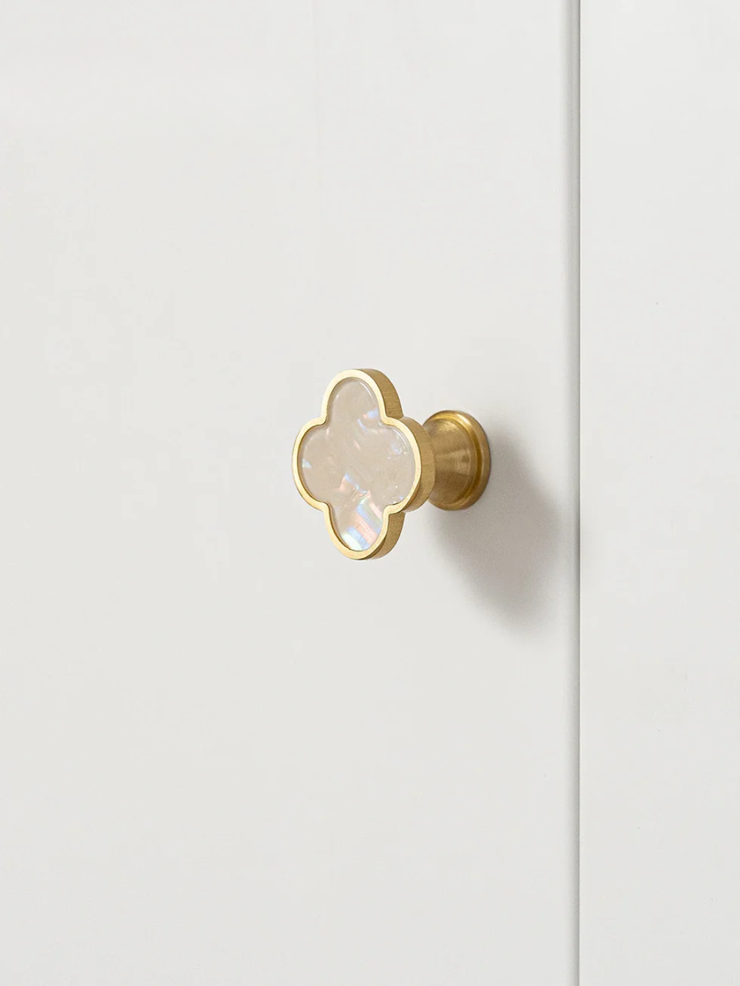 Decorative door handle with marble-like center on a white background