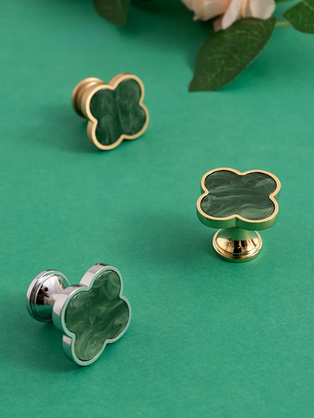 Clover-shaped knobs on a green background with floral elements