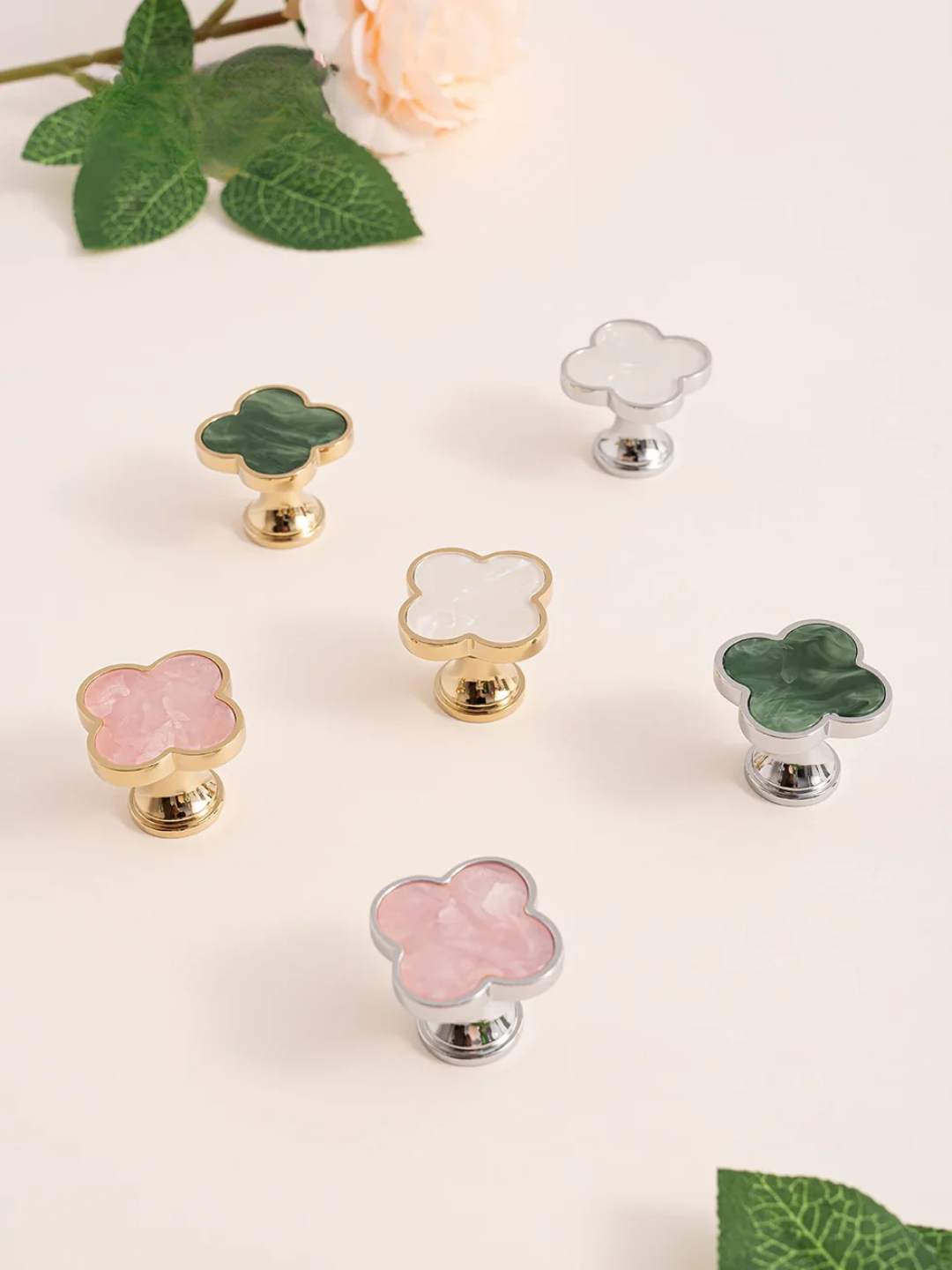 Set of floral cabinet knobs in various colors on a light background