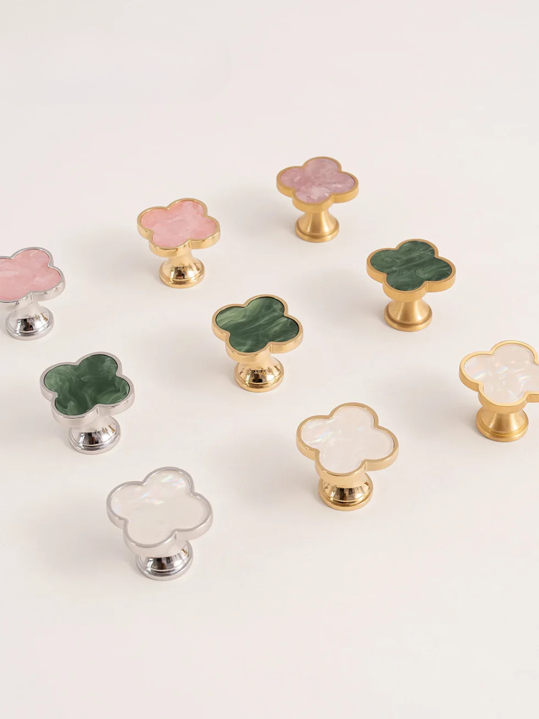 Set of colorful clover-shaped knobs on a white background